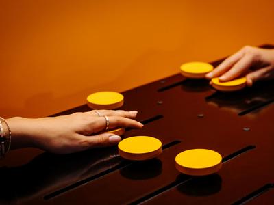 Hands operate yellow buttons