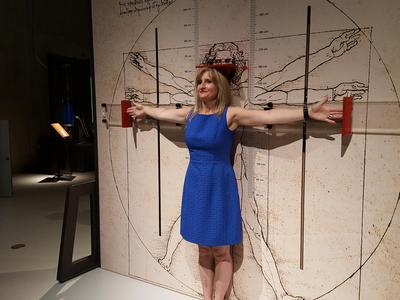 Woman standing in front of Leonardo Da Vinci artwork