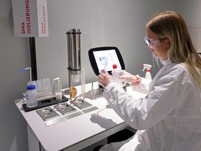 Girl in a white coat in the lab