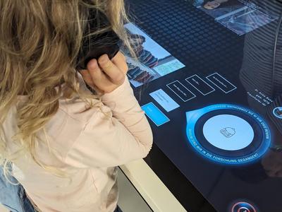 Little girl communicates with scientists at the exhibit